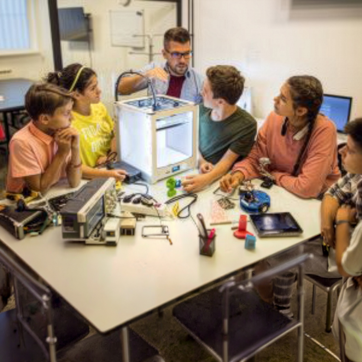 Teacher and students collaborating on an innovation project